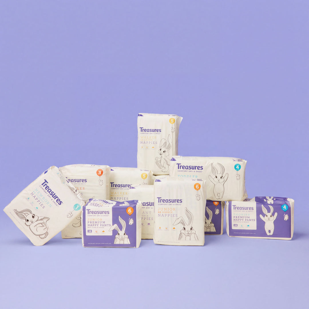 The Treasures nappy and nappy pant range stacked against a periwinkle backdrop
